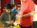 Most Number Of People Making Orange Handicrafts Together