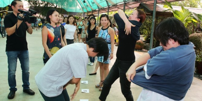 Fastest Time To Pass 10 T-shirts Along A 100-People Chain