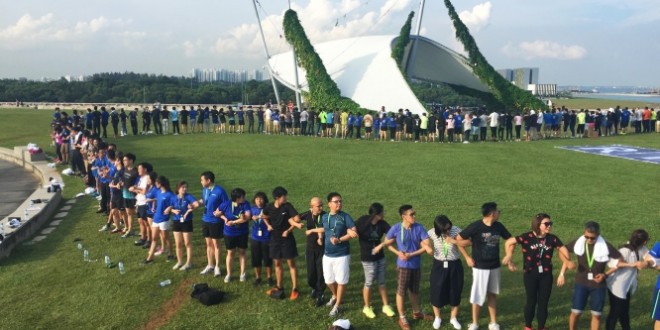 Most Arm-Linked People To Stand Up Simultaneously